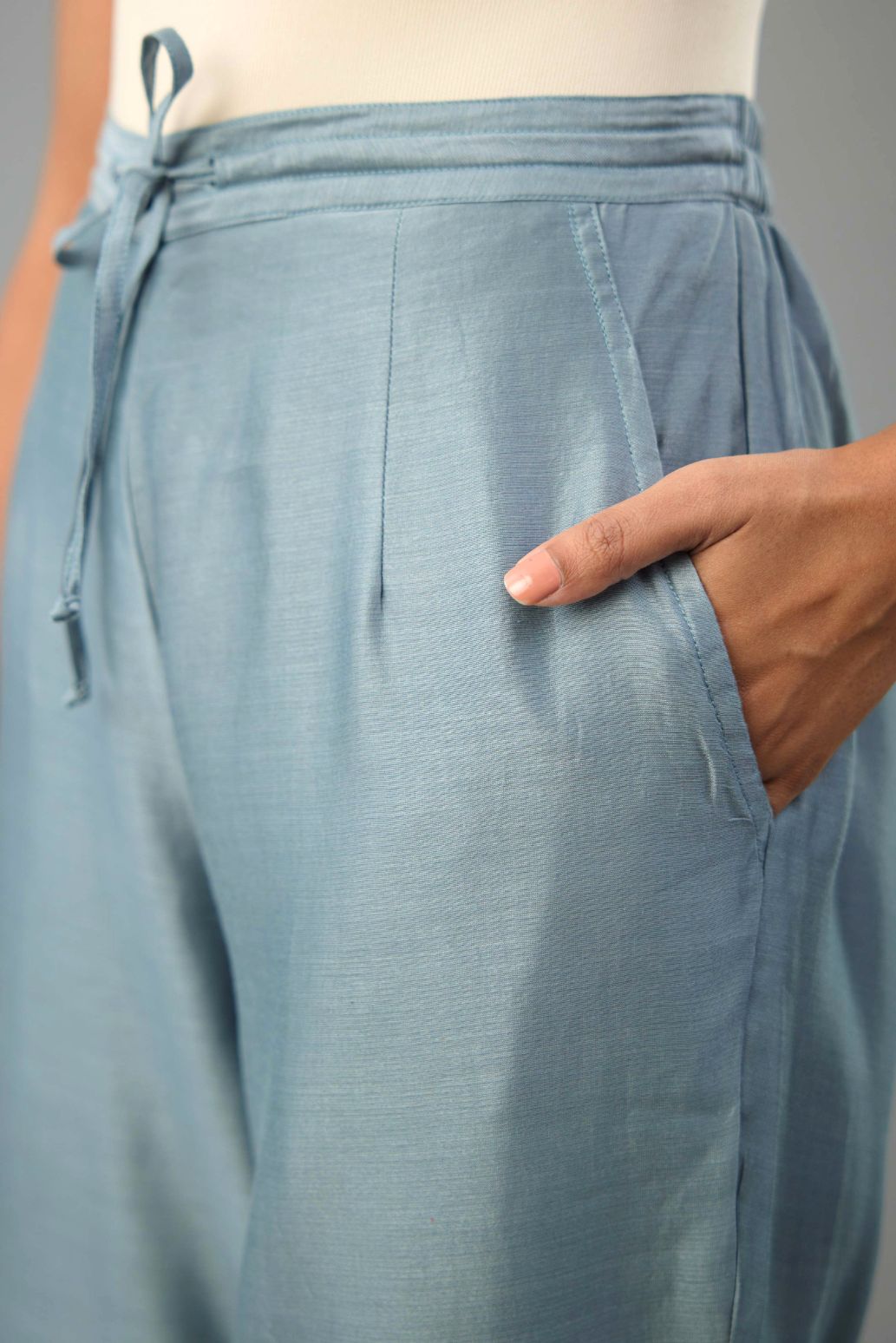 Light blue silk chanderi straight pants with dori and contrast silk thread embroidery,  detailed with gold sequins work.