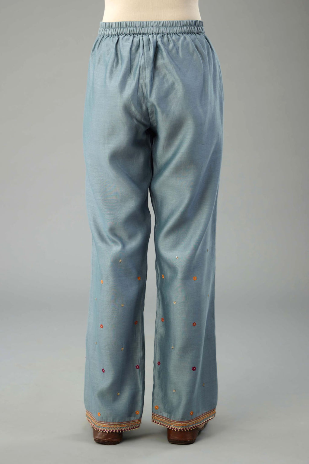 Light blue silk chanderi straight pants with dori and contrast silk thread embroidery,  detailed with gold sequins work.