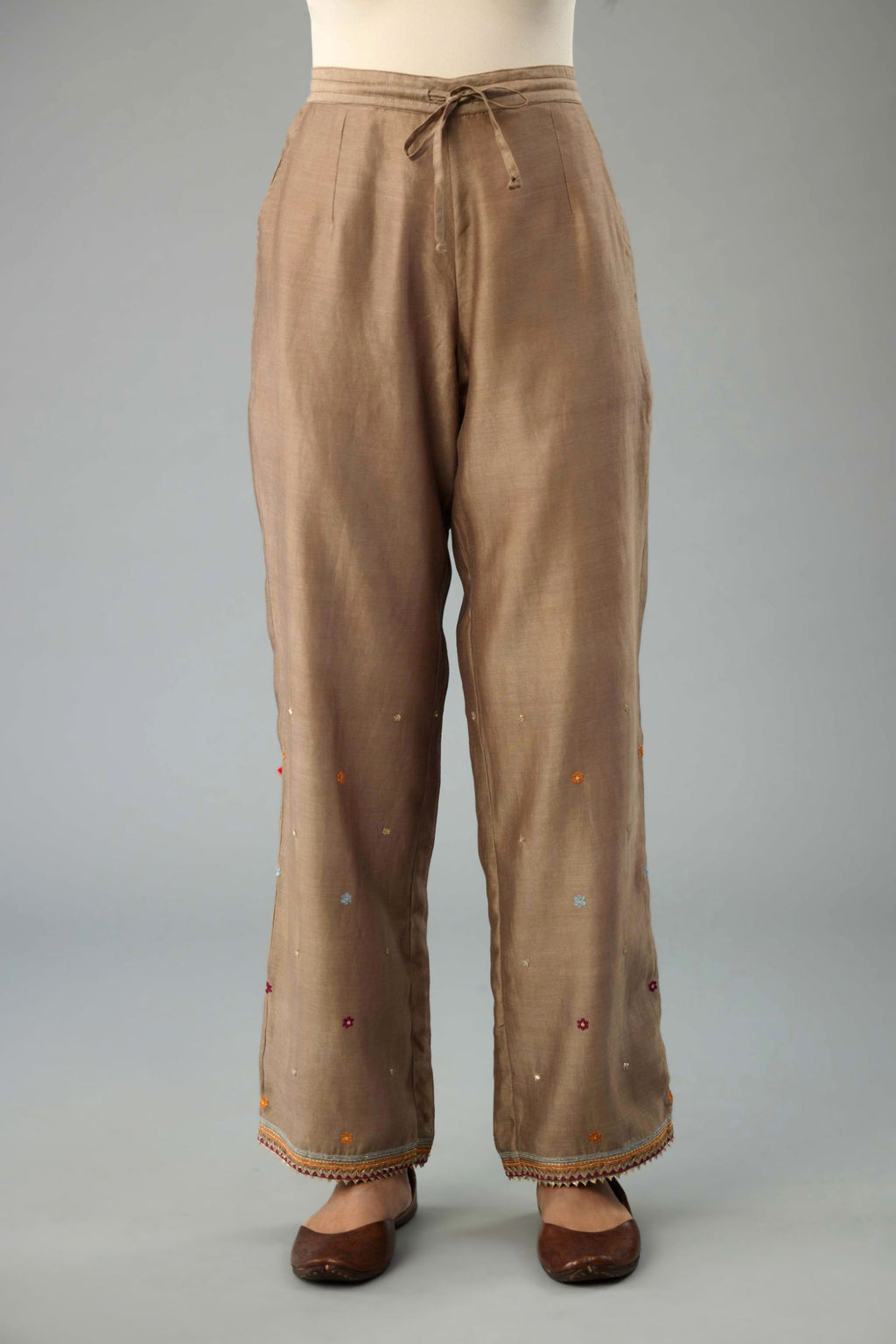 Taupe silk chanderi straight pants with dori and contrast silk thread embroidery,  detailed with gold sequins work.