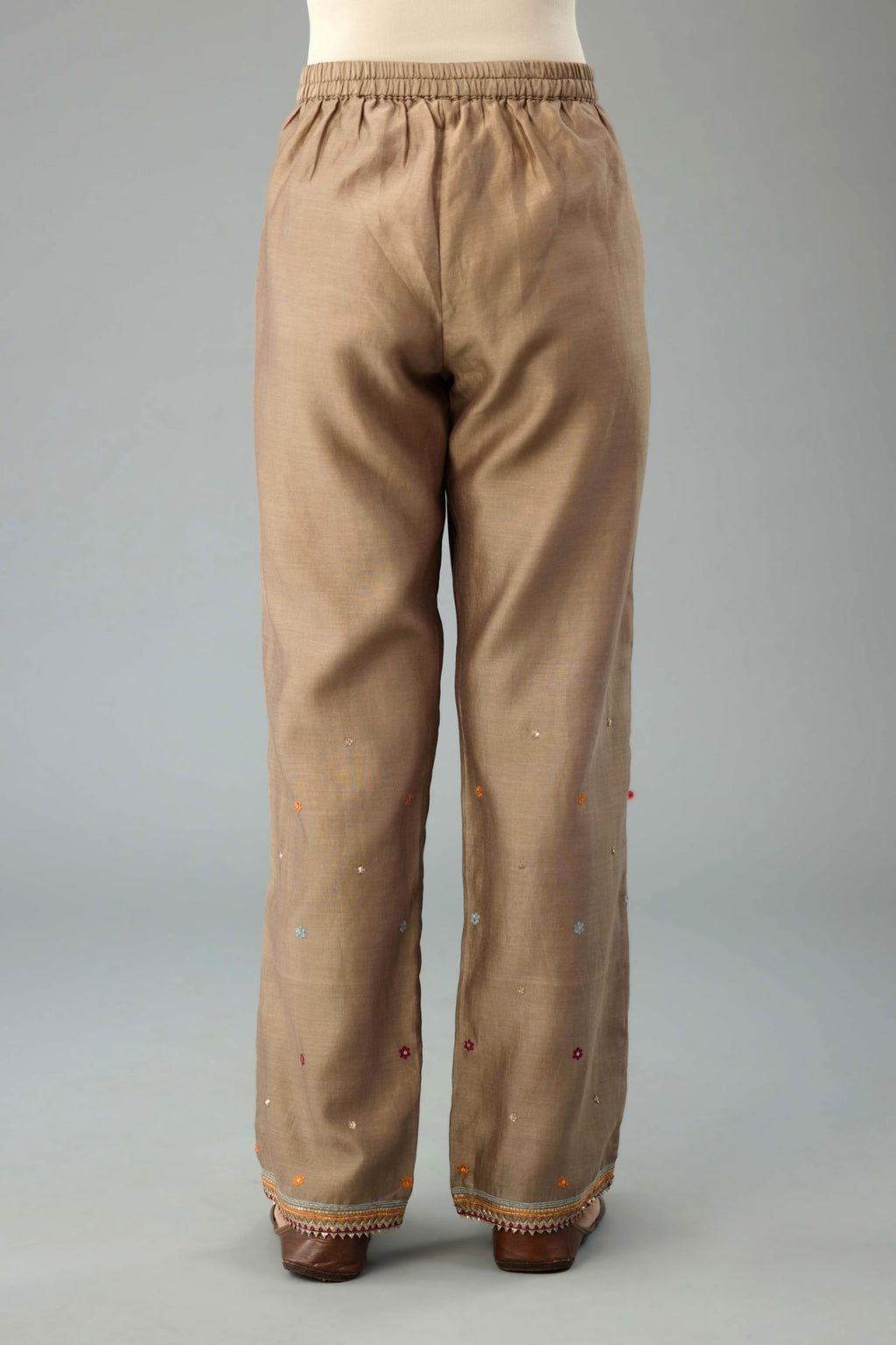 Taupe silk chanderi straight pants with dori and contrast silk thread embroidery,  detailed with gold sequins work.
