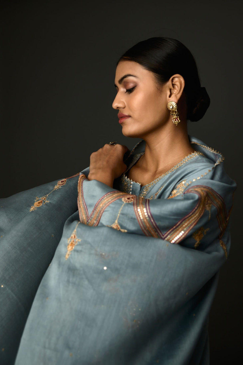 Light blue Silk chanderi dupatta in chevron pattern embroidery with contrast silk thread and dori at the sides.