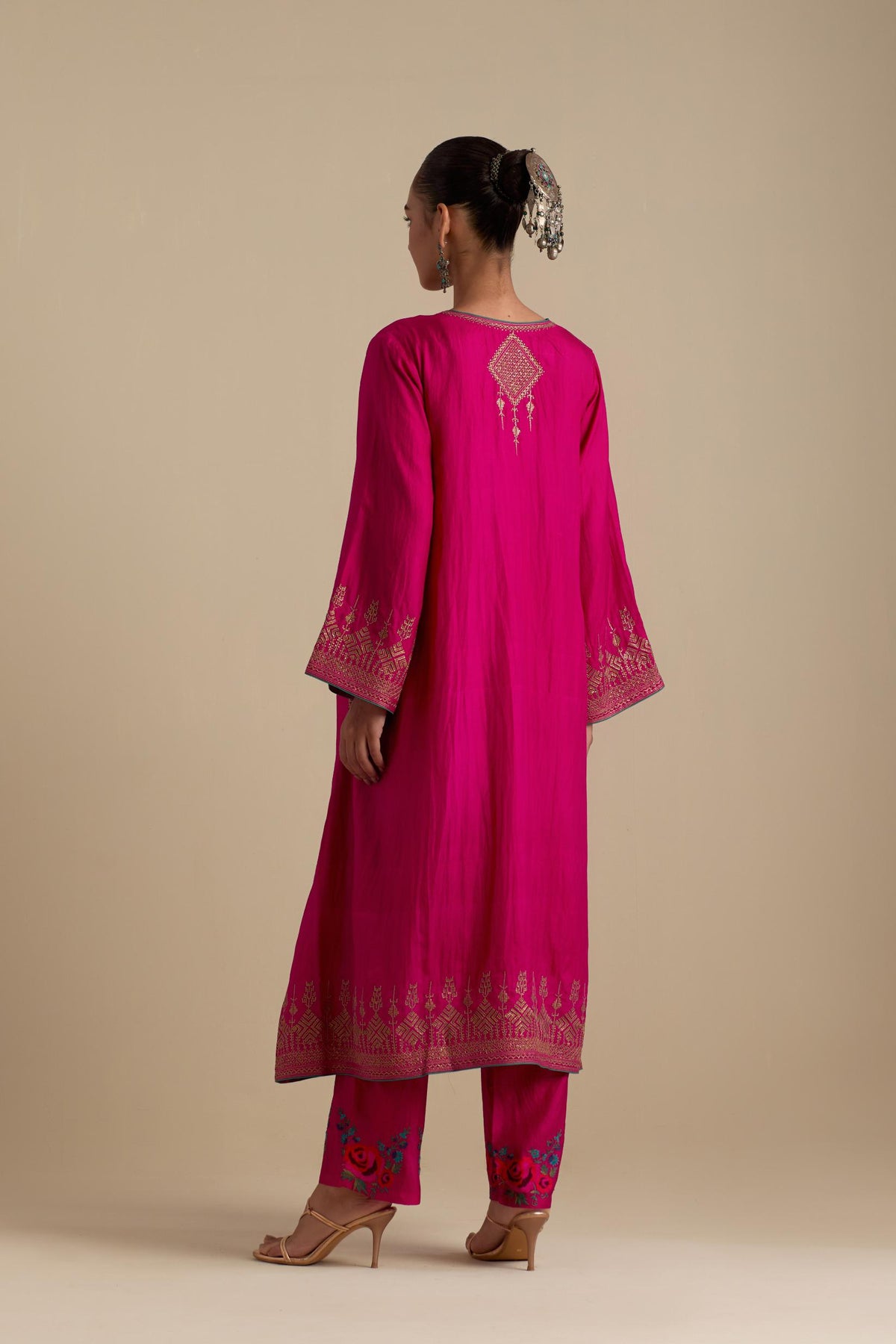 Fuchsia knee length A-line kurta set, highlighted with dull gold zari and sequins handwork.