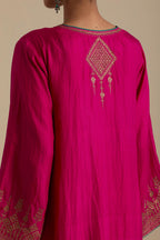 Fuchsia knee length A-line kurta set, highlighted with dull gold zari and sequins handwork.