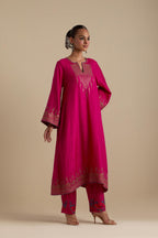 Fuchsia knee length A-line kurta set, highlighted with dull gold zari and sequins handwork.