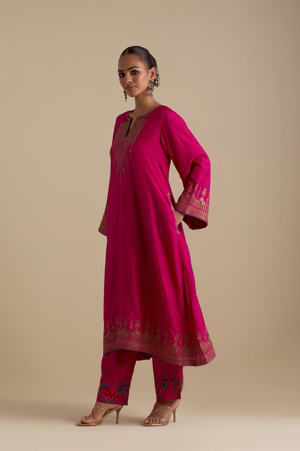 Fuchsia knee length A-line kurta set, highlighted with dull gold zari and sequins handwork.
