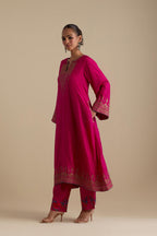 Fuchsia knee length A-line kurta set, highlighted with dull gold zari and sequins handwork.