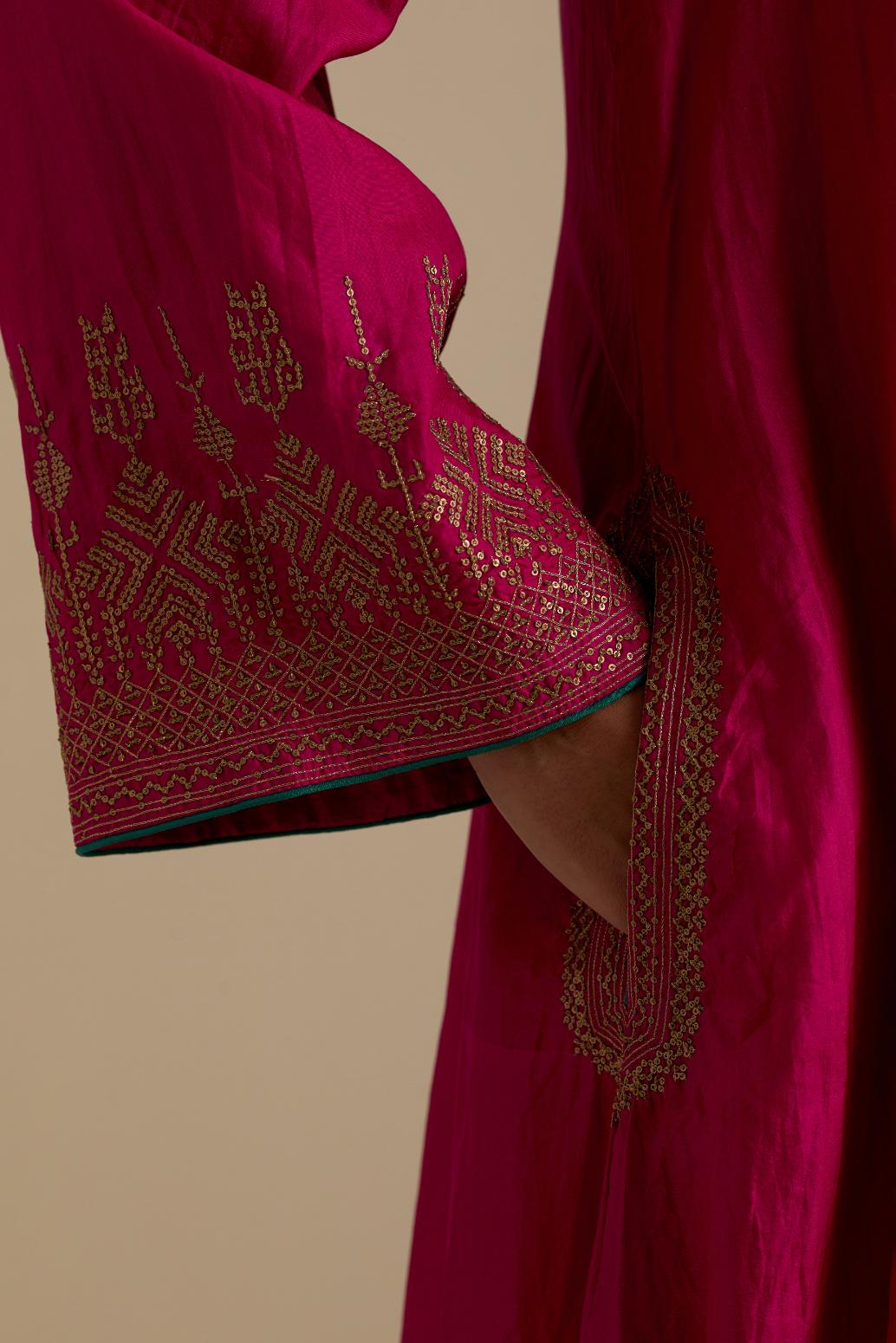 Fuchsia knee length A-line kurta set, highlighted with dull gold zari and sequins handwork.