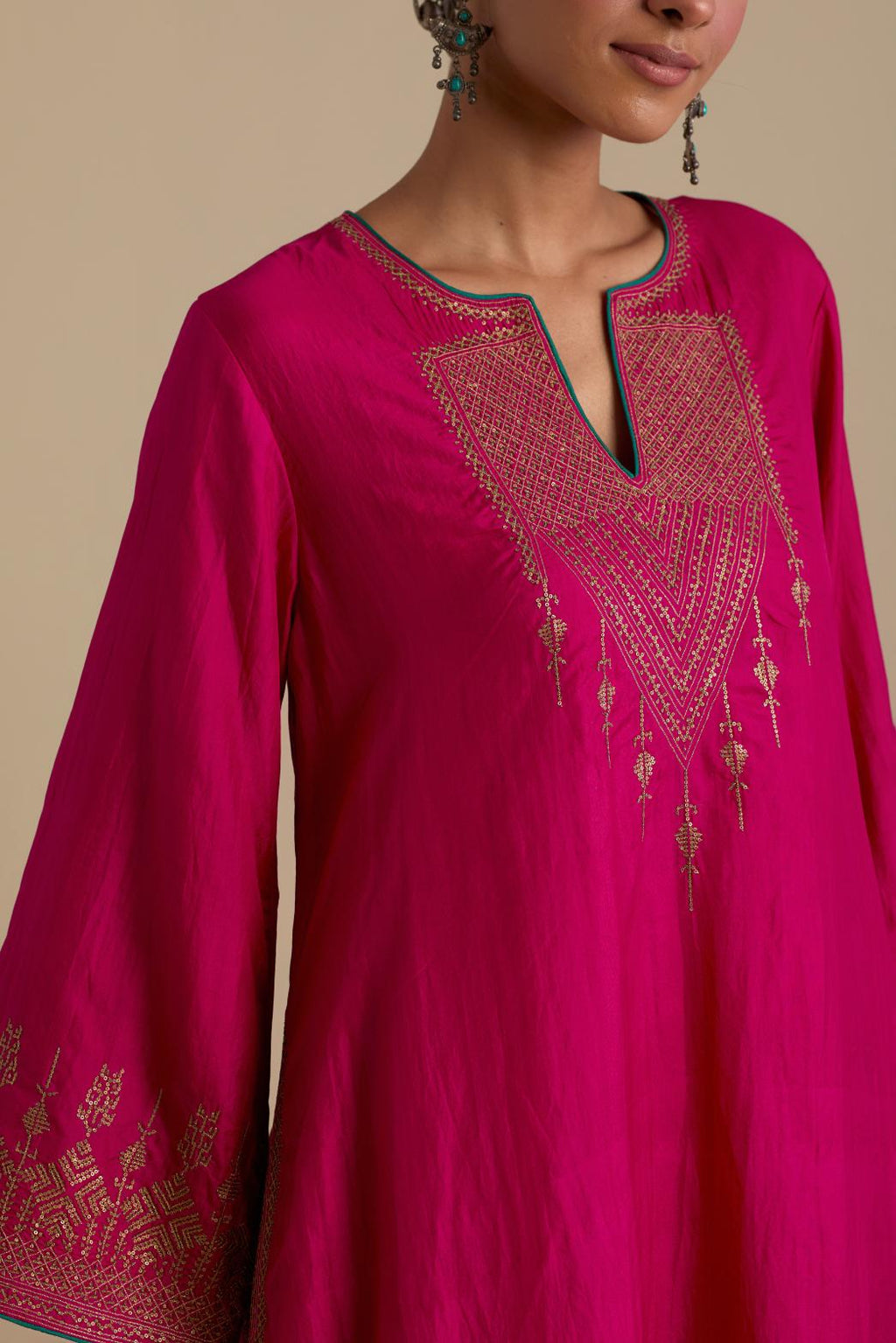 Fuchsia knee length A-line kurta set, highlighted with dull gold zari and sequins handwork.