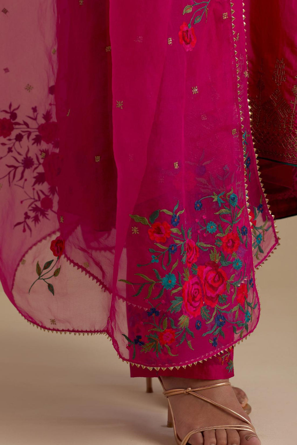 Fuchsia knee length A-line kurta set, highlighted with dull gold zari and sequins handwork.