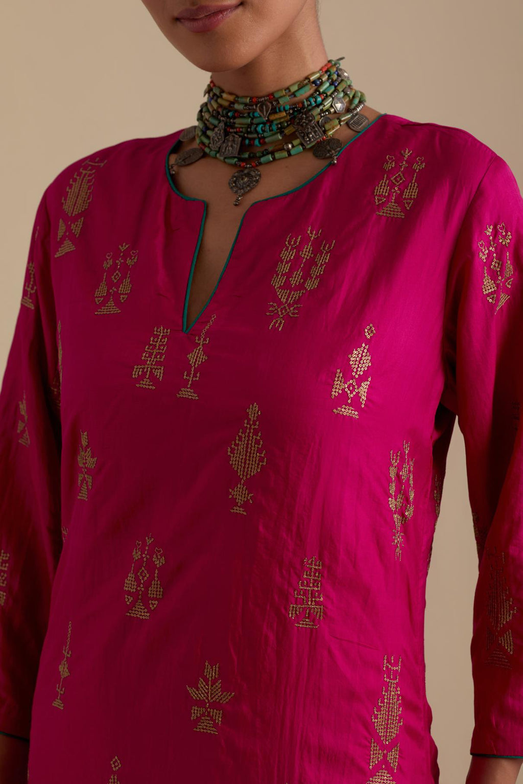 Fuchsia silk straight long kurta set, highlighted with dull gold zari and sequins handwork.