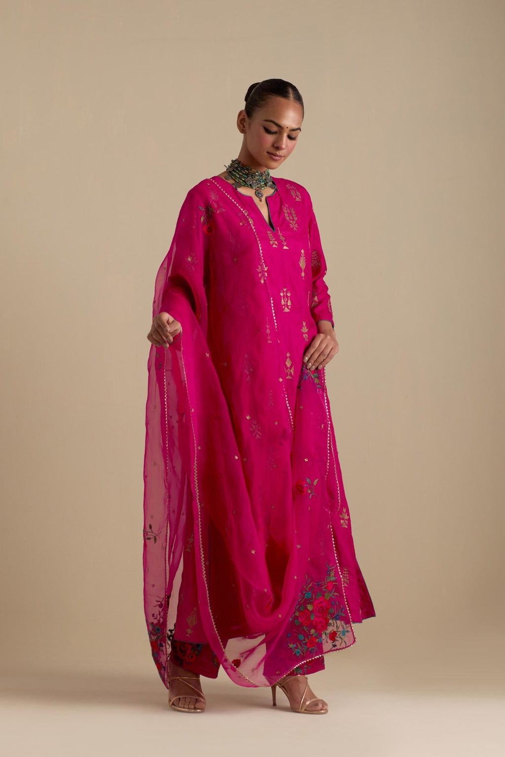 Fuchsia silk straight long kurta set, highlighted with dull gold zari and sequins handwork.