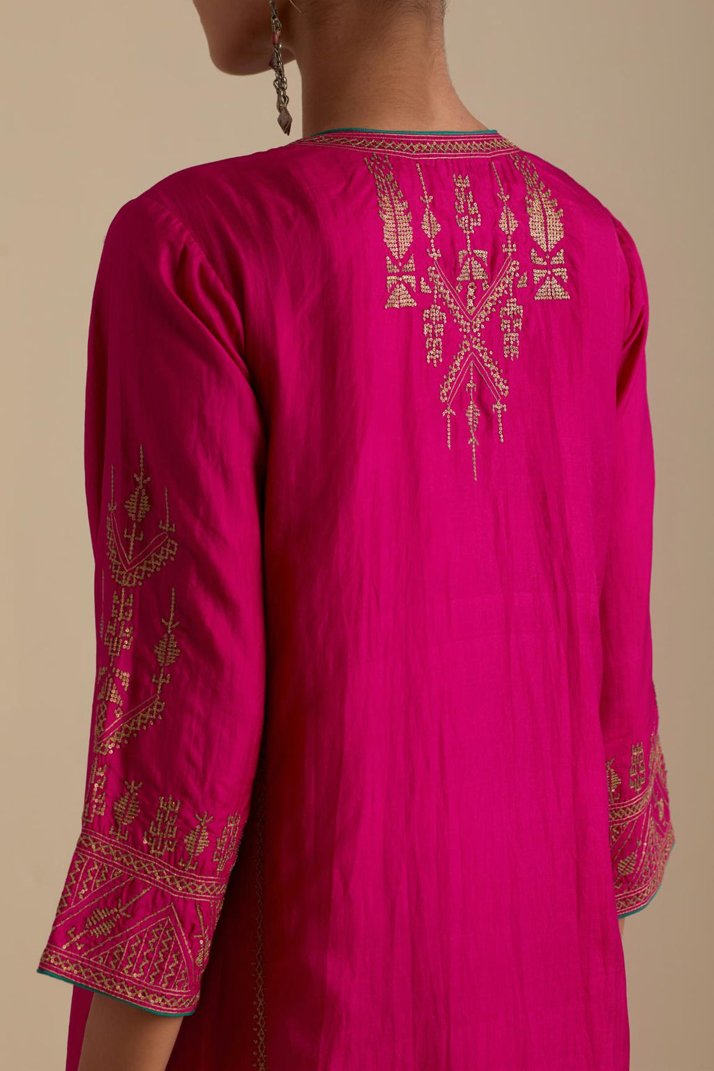 Fuchsia silk straight long kurta set with side panels, highlighted with dull gold zari and sequins handwork.