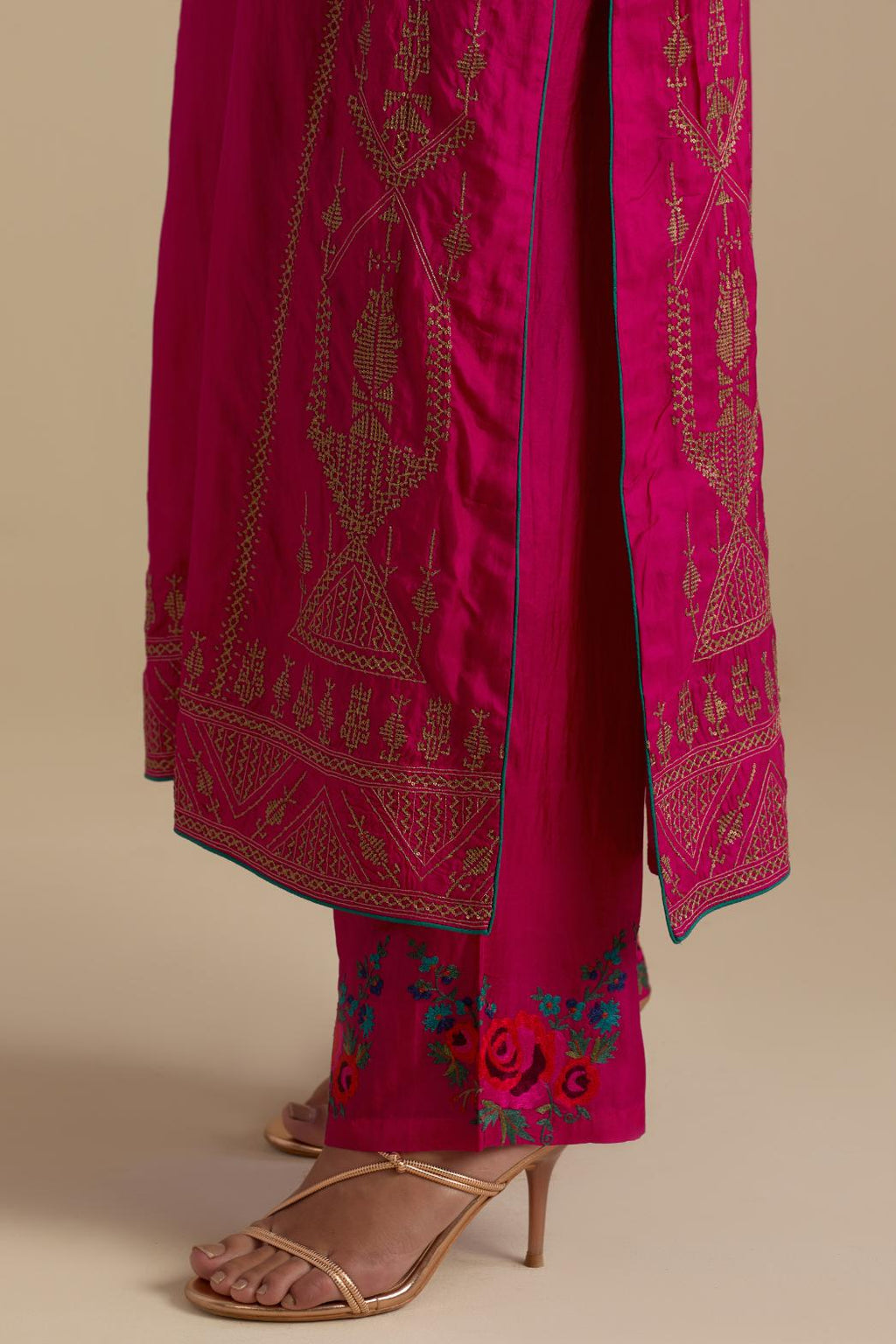 Fuchsia silk straight long kurta set with side panels, highlighted with dull gold zari and sequins handwork.