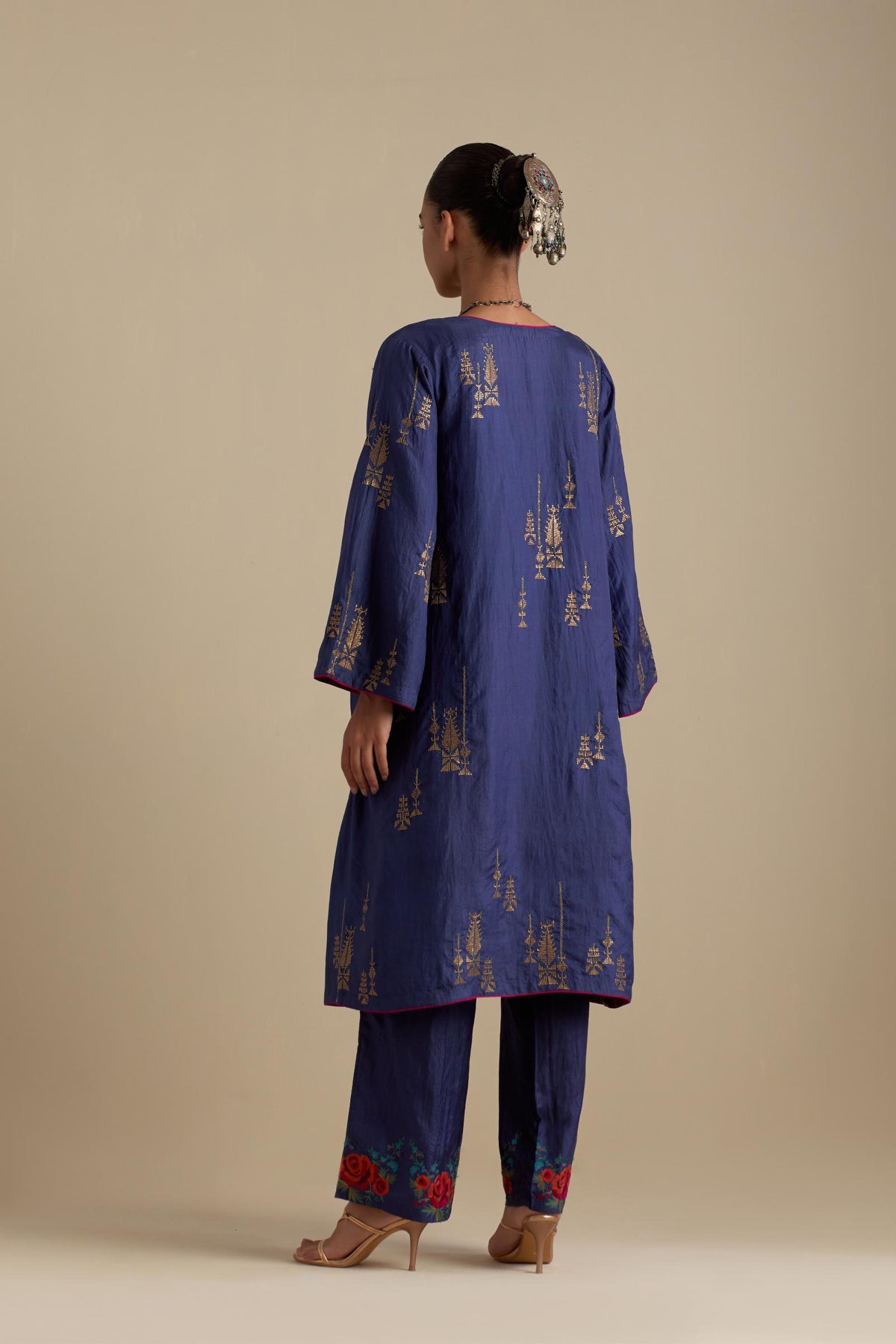 Blue silk A-line short kurta set, highlighted with dull gold zari and sequins handwork.