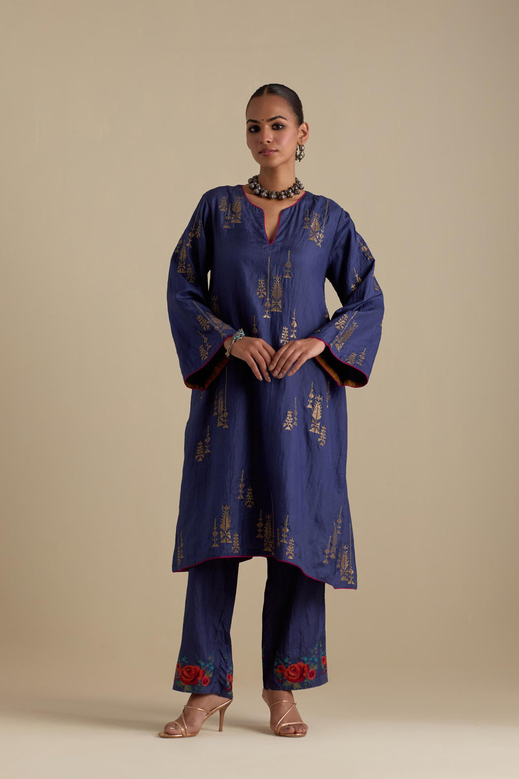 Blue silk A-line short kurta set, highlighted with dull gold zari and sequins handwork.