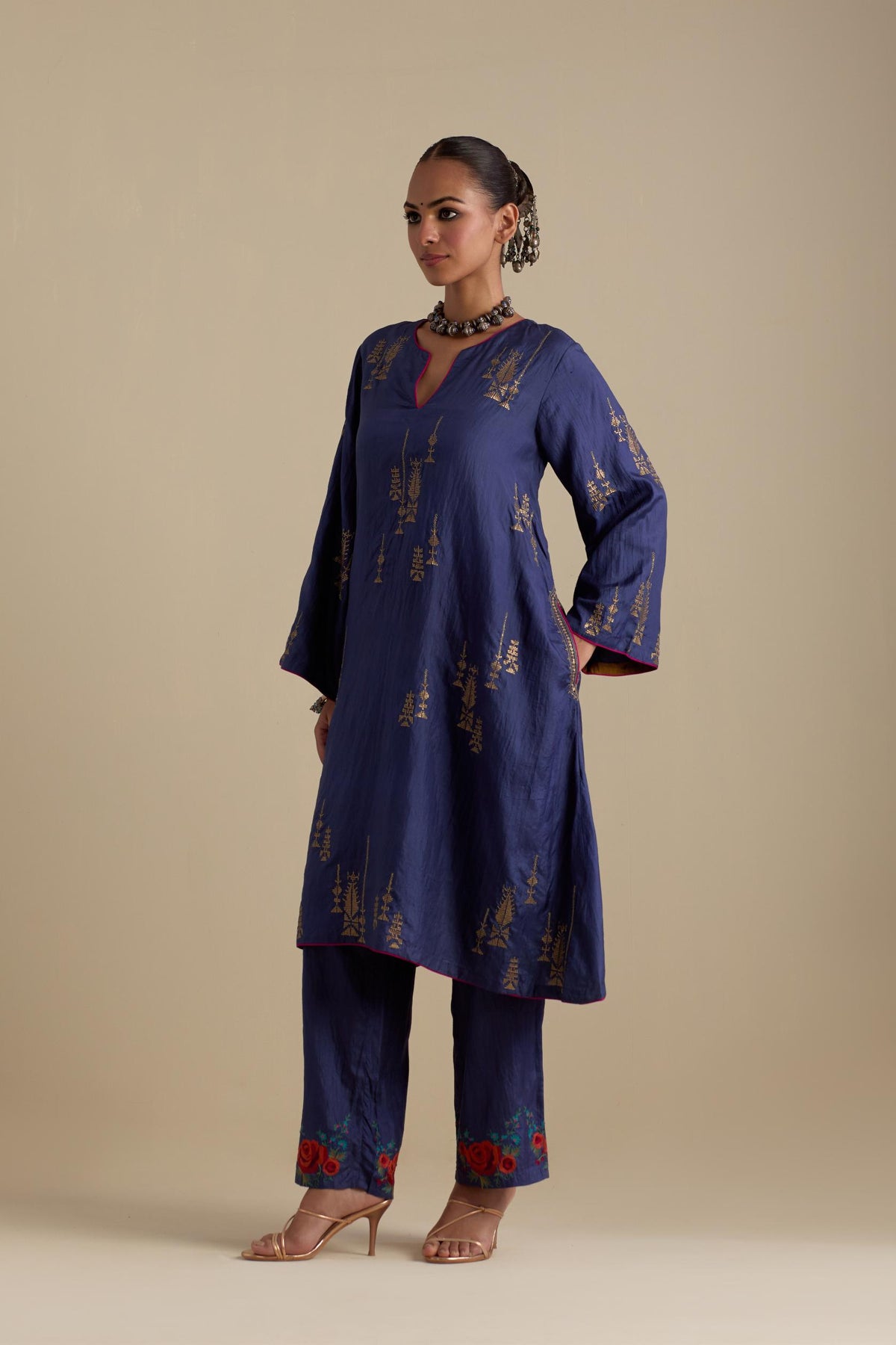 Blue silk A-line short kurta set, highlighted with dull gold zari and sequins handwork.