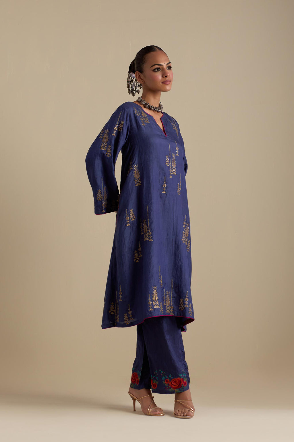 Blue silk A-line short kurta set, highlighted with dull gold zari and sequins handwork.