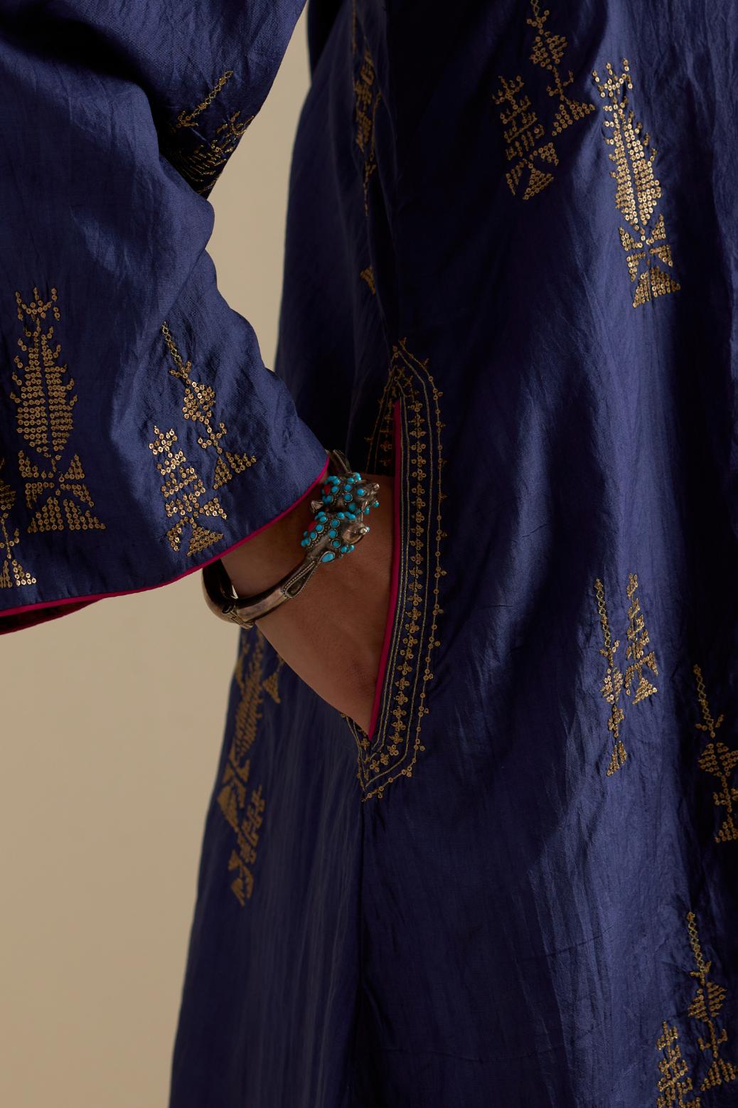 Blue silk A-line short kurta set, highlighted with dull gold zari and sequins handwork.