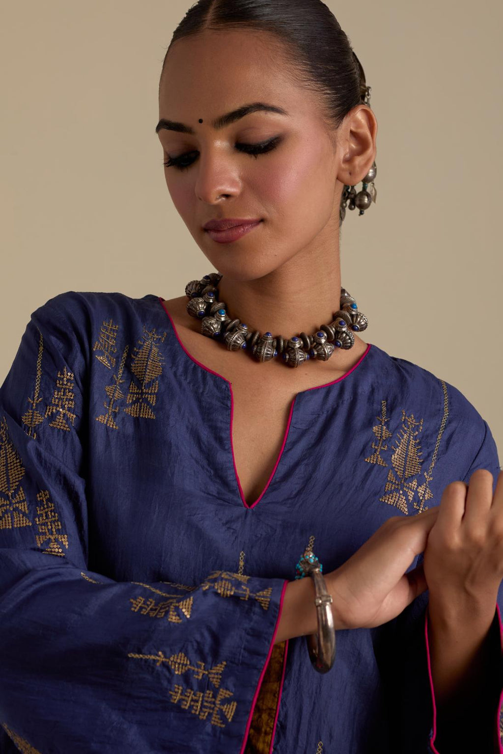 Blue silk A-line short kurta set, highlighted with dull gold zari and sequins handwork.