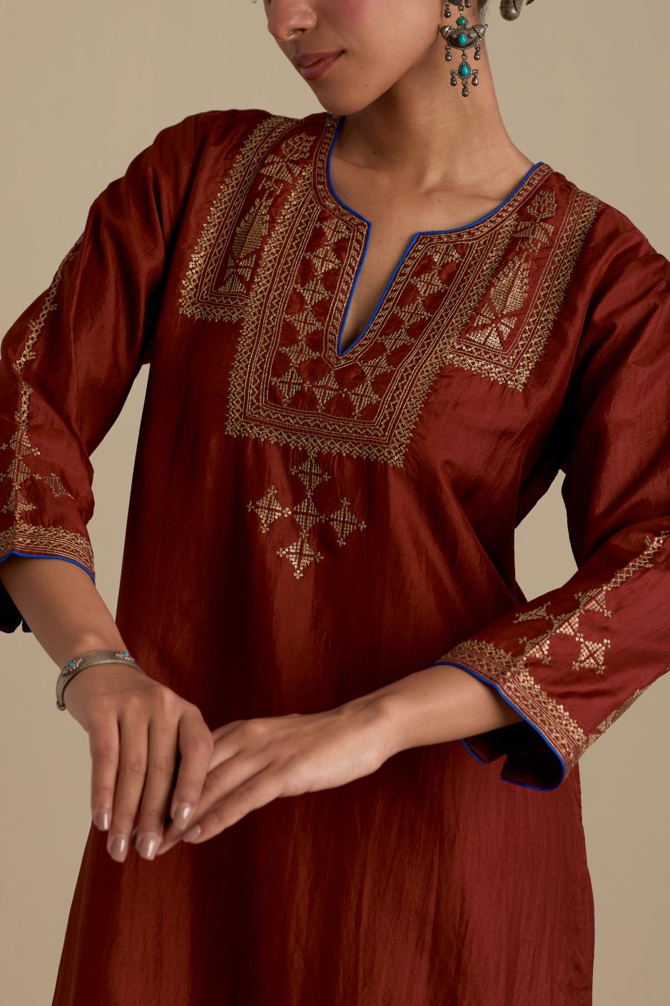 Maroon silk straight kurta set, highlighted with dull gold zari and sequins handwork.