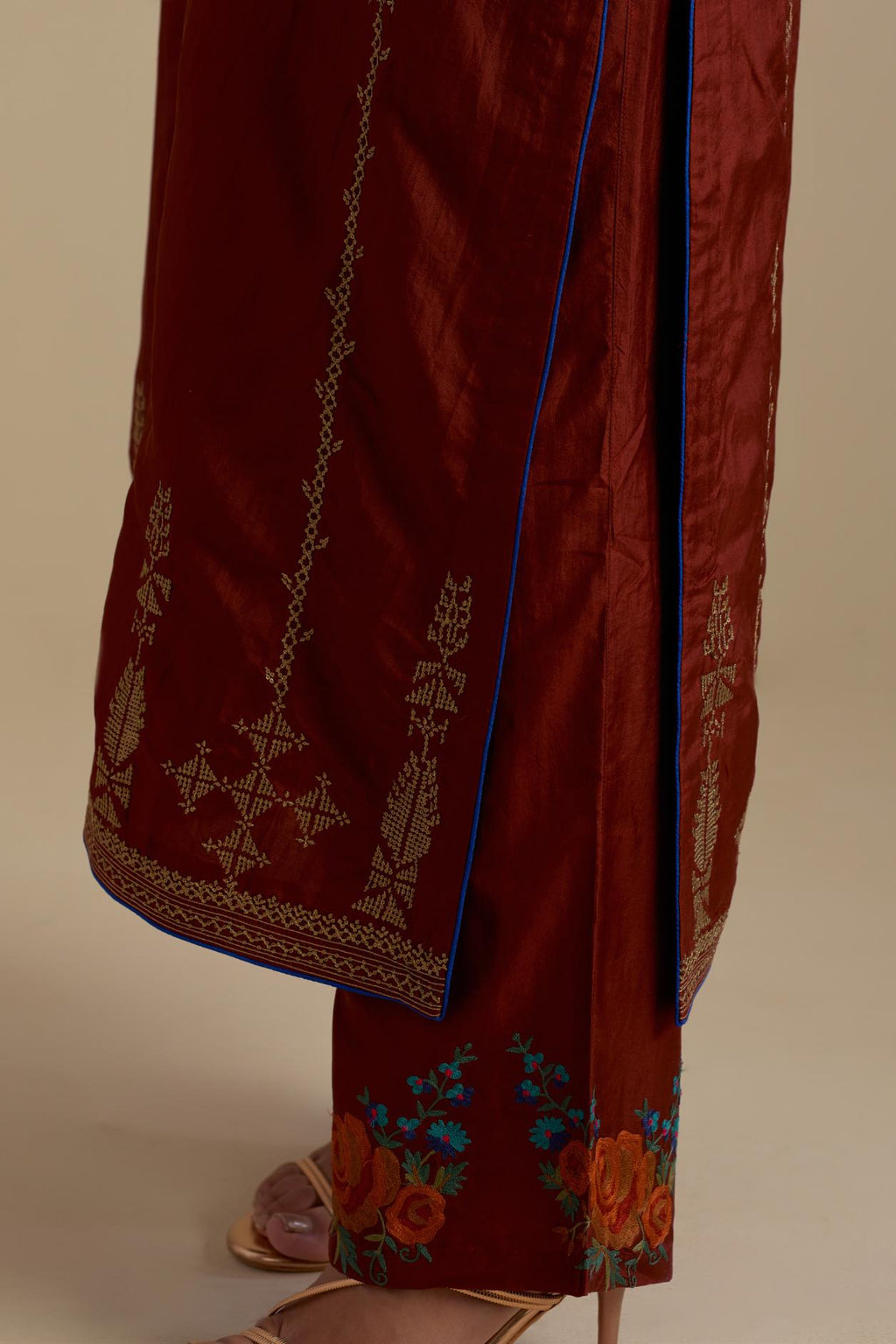 Maroon silk straight kurta set, highlighted with dull gold zari and sequins handwork.