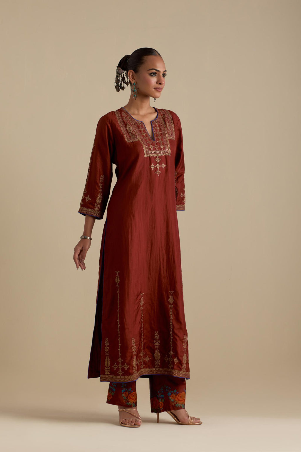 Maroon silk straight kurta set, highlighted with dull gold zari and sequins handwork.