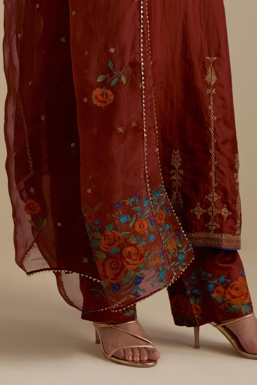 Maroon silk straight kurta set, highlighted with dull gold zari and sequins handwork.