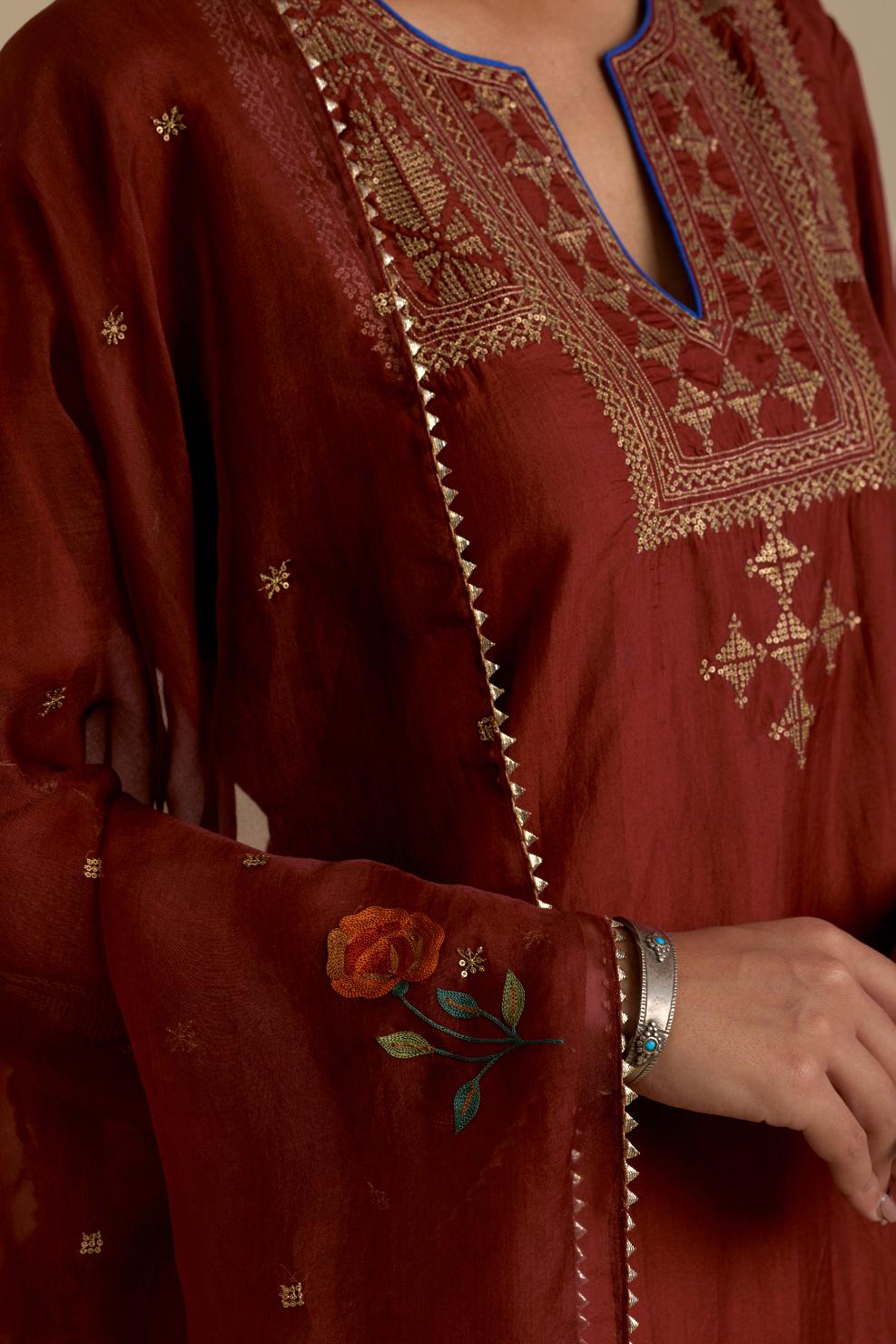 Maroon silk straight kurta set, highlighted with dull gold zari and sequins handwork.