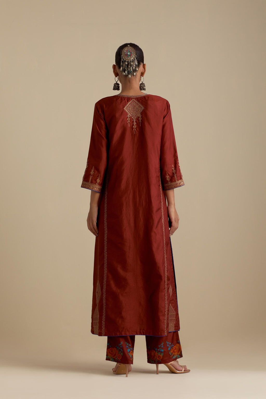 Maroon silk straight kurta set, highlighted with dull gold zari and sequins handwork.