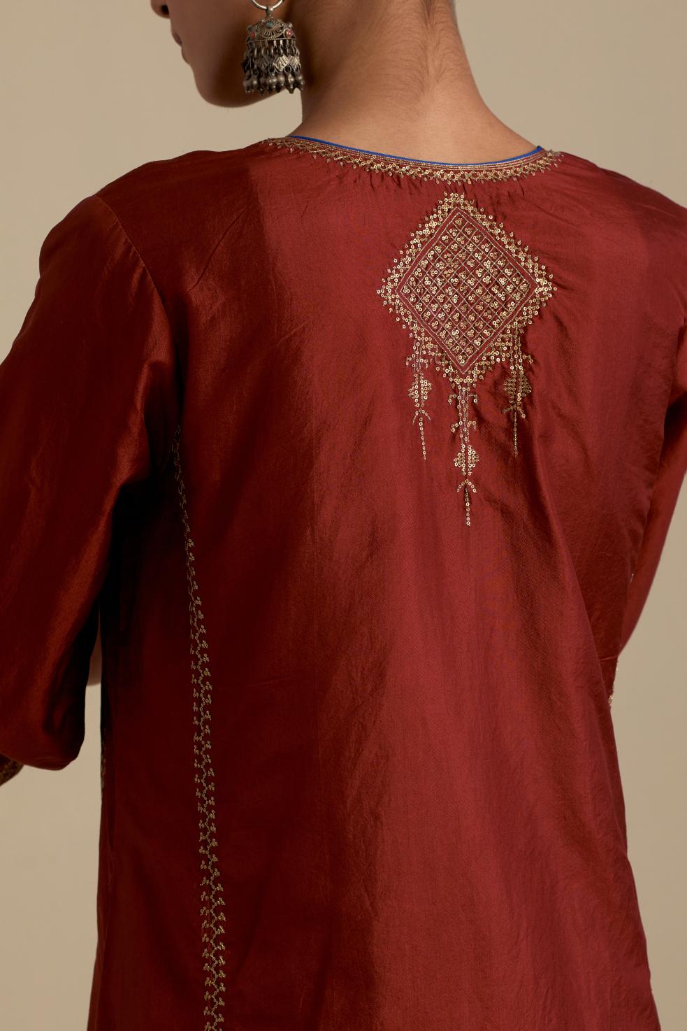 Maroon silk straight kurta set, highlighted with dull gold zari and sequins handwork.