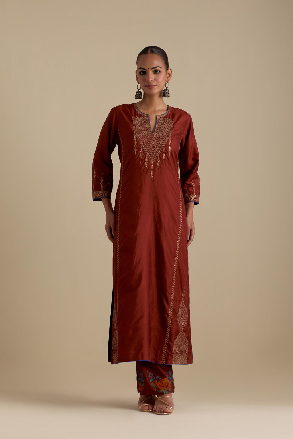 Maroon silk straight kurta set, highlighted with dull gold zari and sequins handwork.