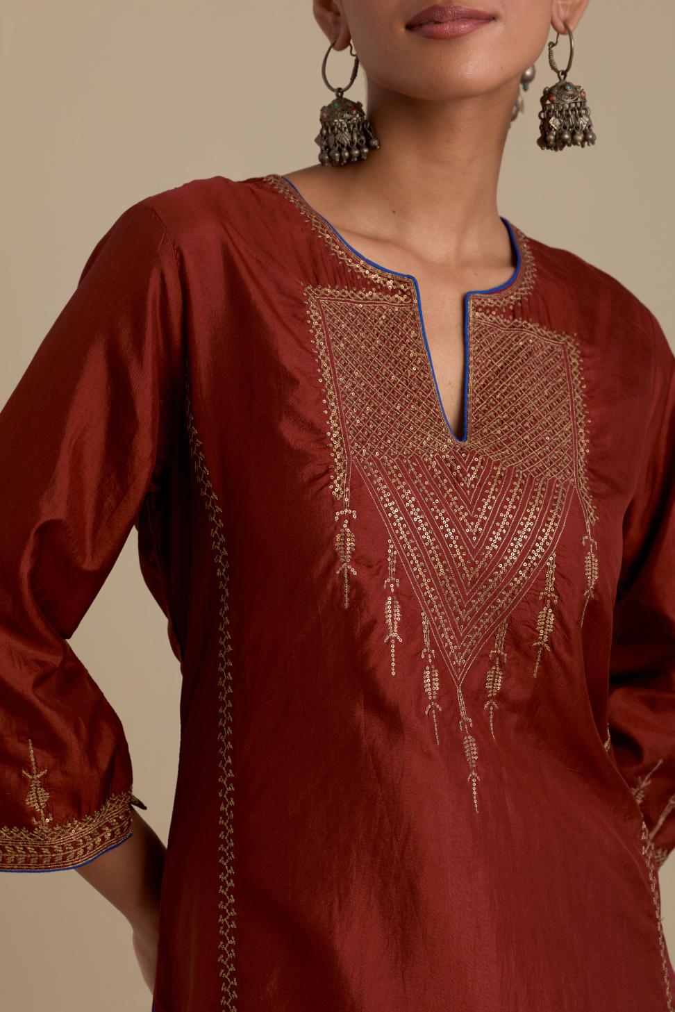 Maroon silk straight kurta set, highlighted with dull gold zari and sequins handwork.