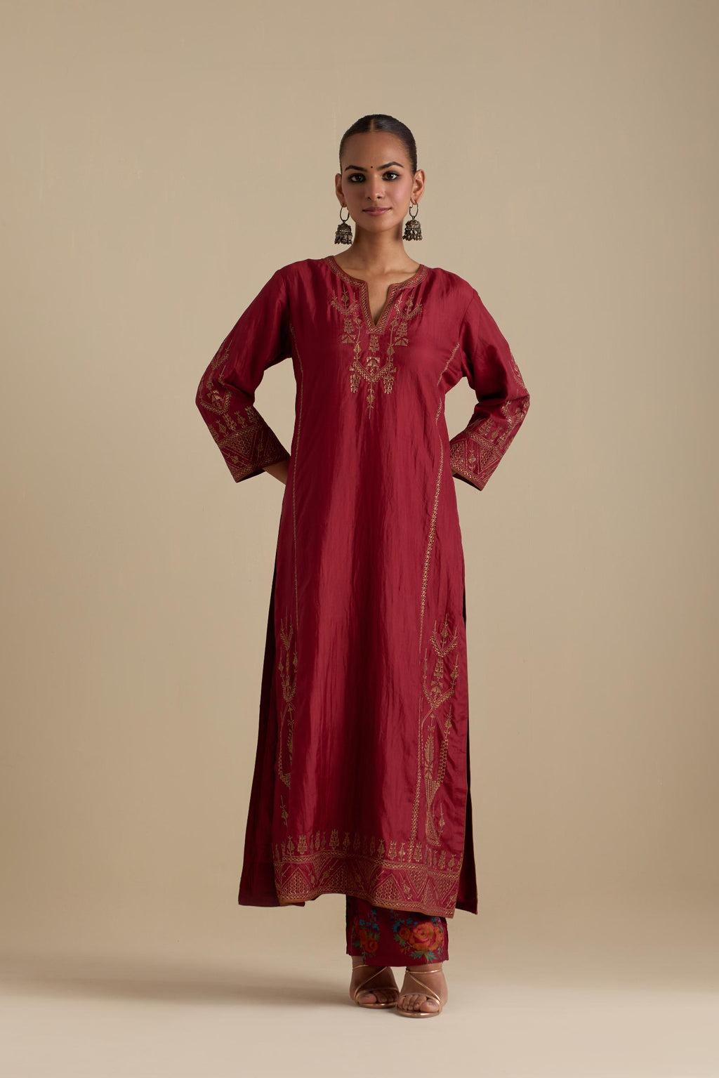 Barn red silk straight long kurta set with side panels, highlighted with dull gold zari and sequins handwork.