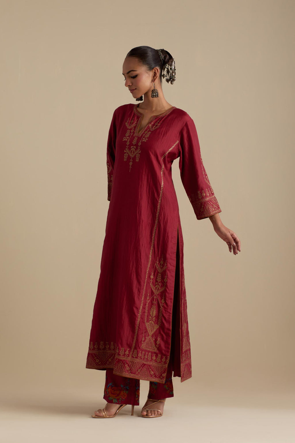 Barn red silk straight long kurta set with side panels, highlighted with dull gold zari and sequins handwork.