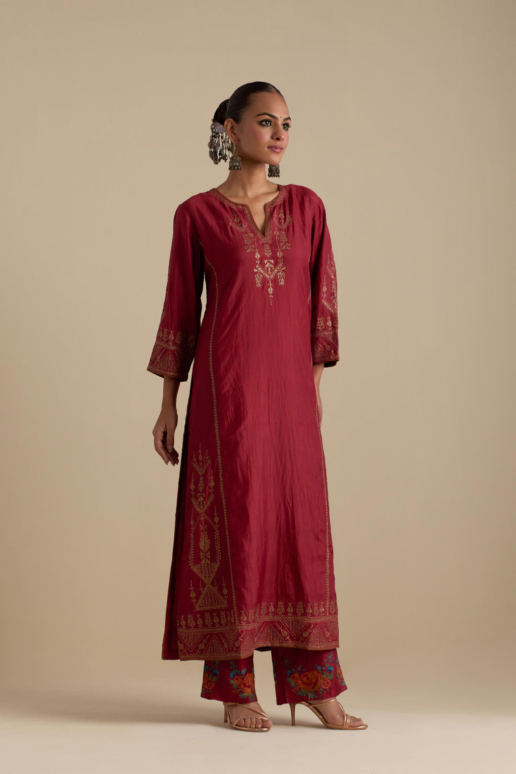 Barn red silk straight long kurta set with side panels, highlighted with dull gold zari and sequins handwork.