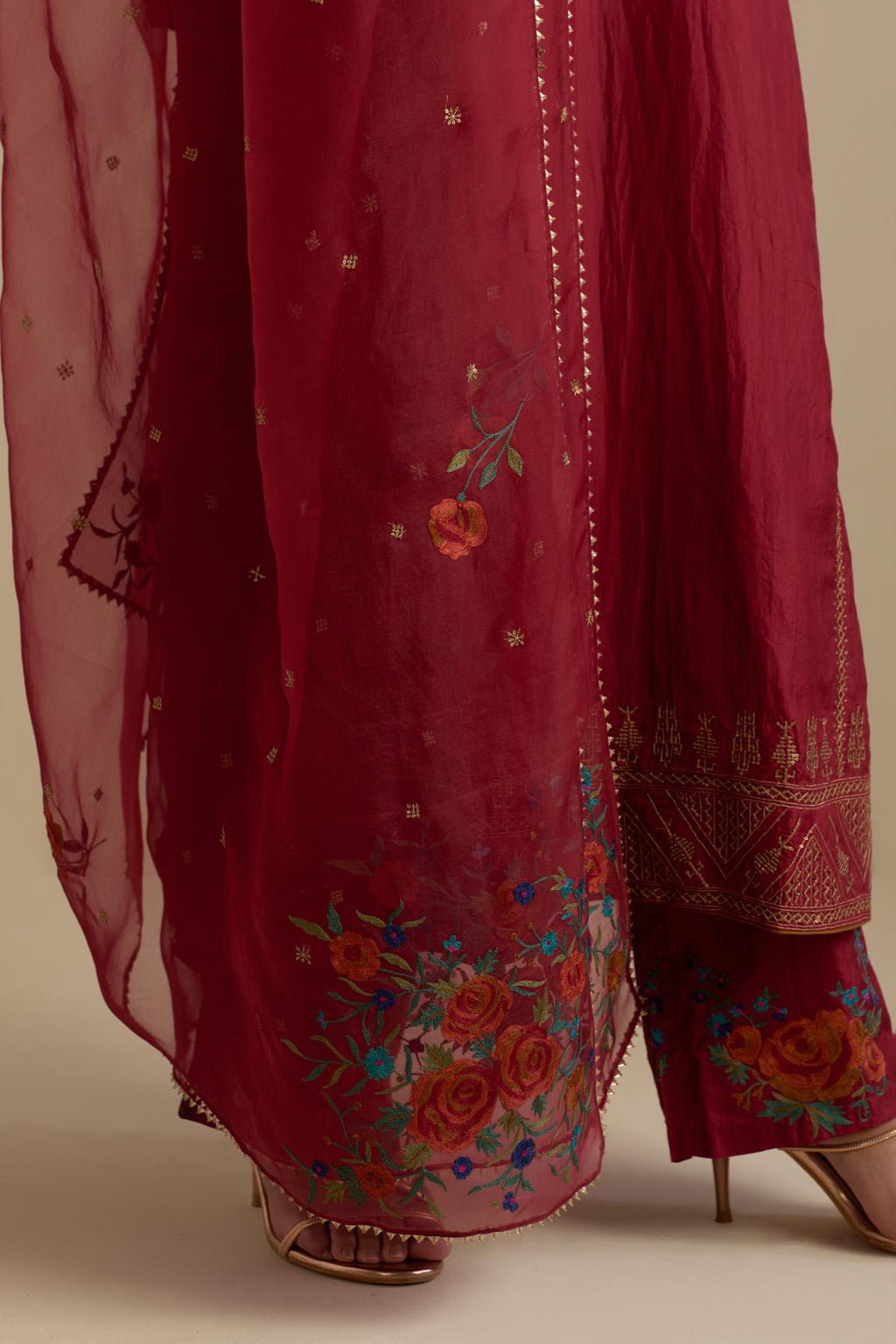 Barn red silk organza dupatta, highlighted with delicate dull gold sequins work and all-over thread embroidery roses, with a large bunch at the dupatta corners.