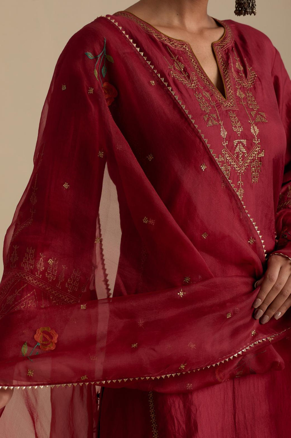 Barn red silk organza dupatta, highlighted with delicate dull gold sequins work and all-over thread embroidery roses, with a large bunch at the dupatta corners.