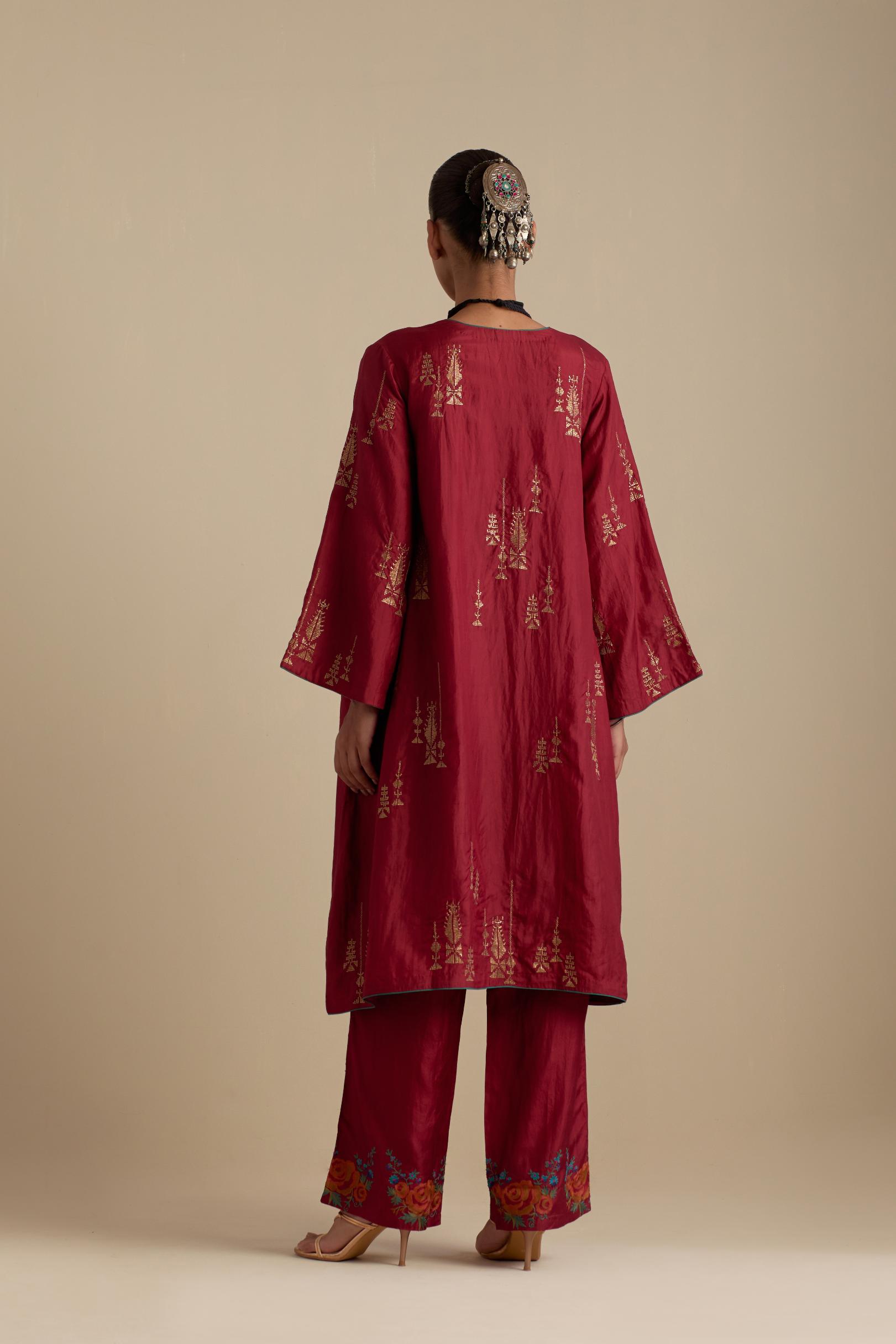 Barn red silk A-line short kurta set, highlighted with dull gold zari and sequins handwork.