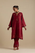 Barn red silk A-line short kurta set, highlighted with dull gold zari and sequins handwork.