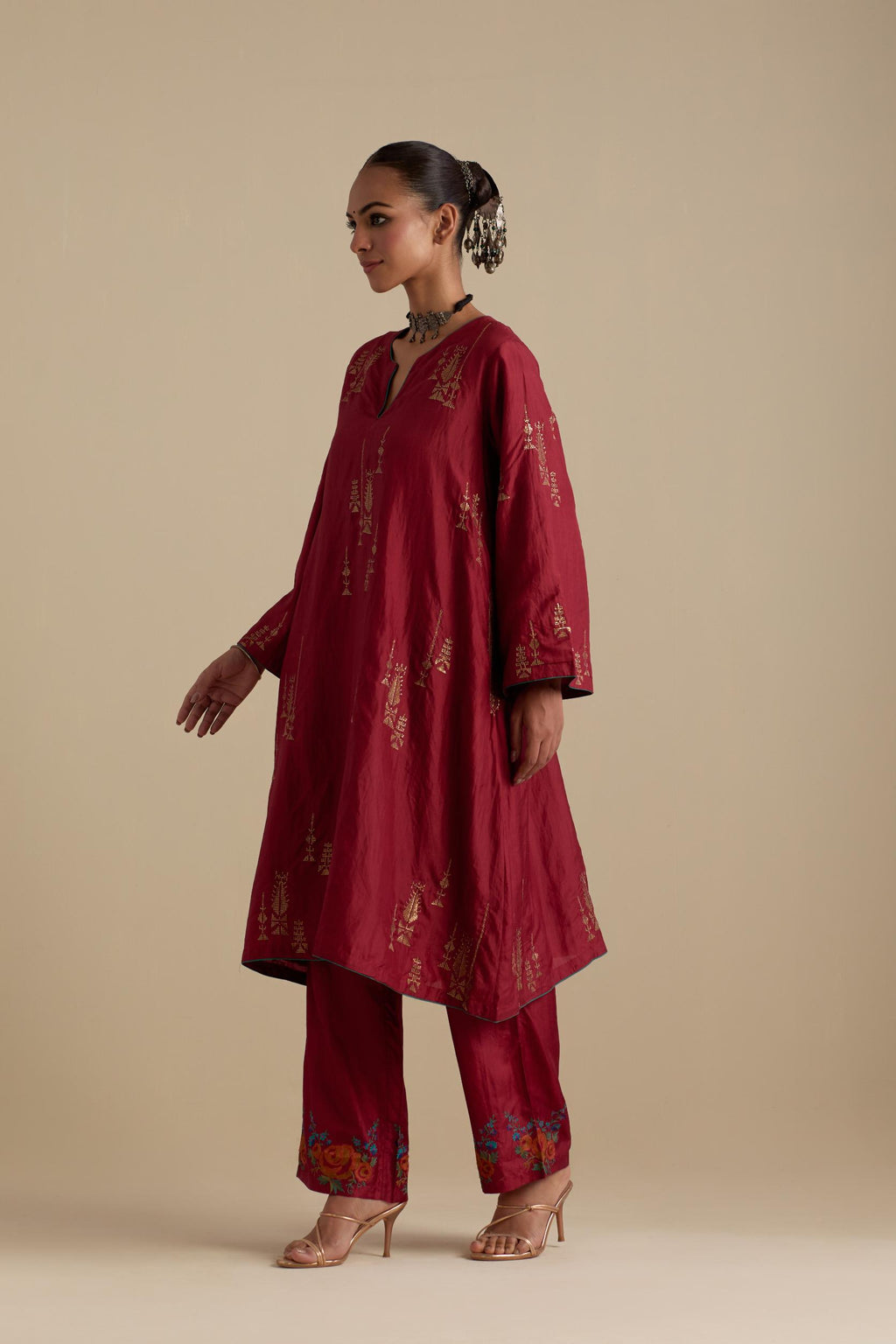 Barn red silk A-line short kurta set, highlighted with dull gold zari and sequins handwork.