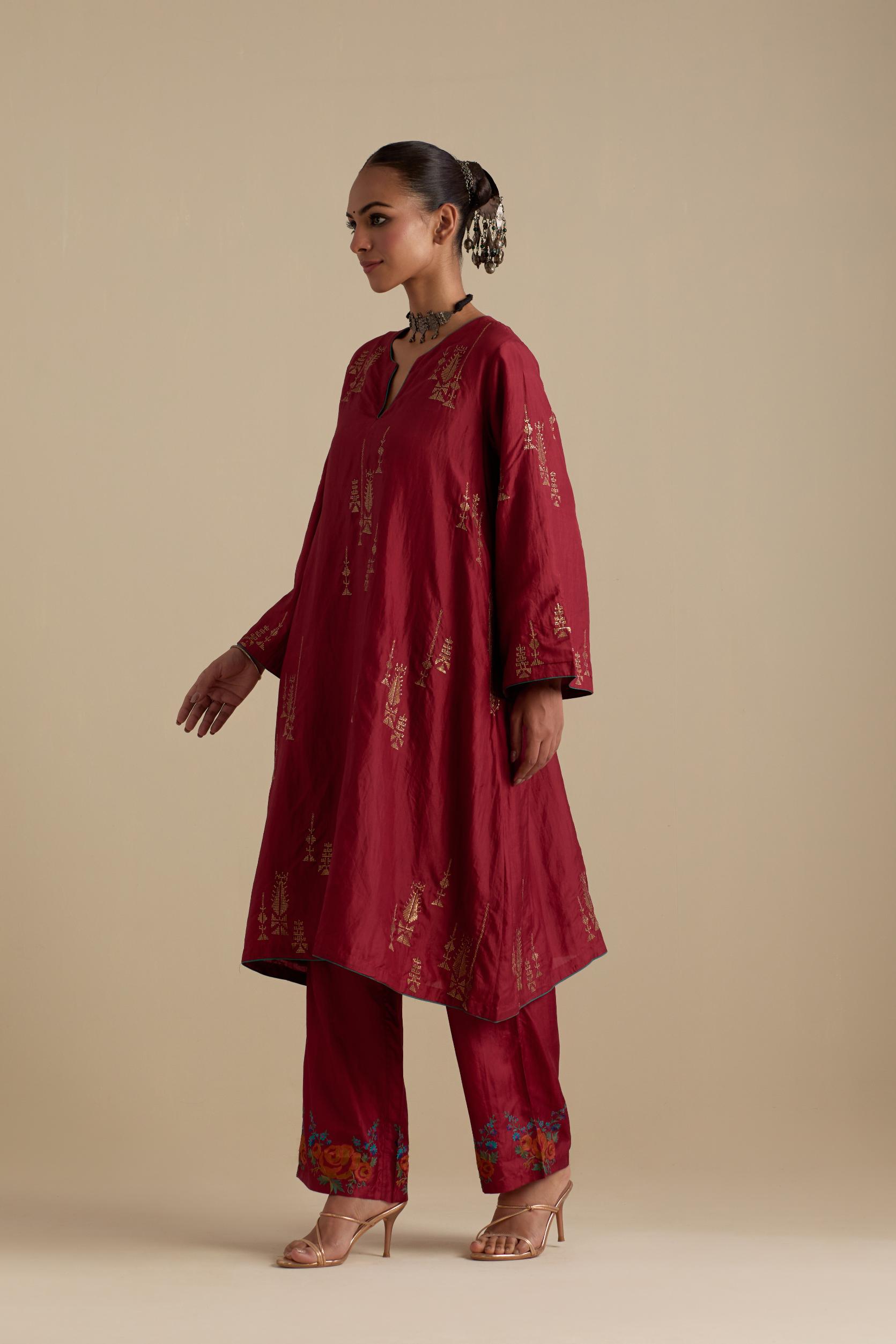 Barn red silk A-line short kurta set, highlighted with dull gold zari and sequins handwork.