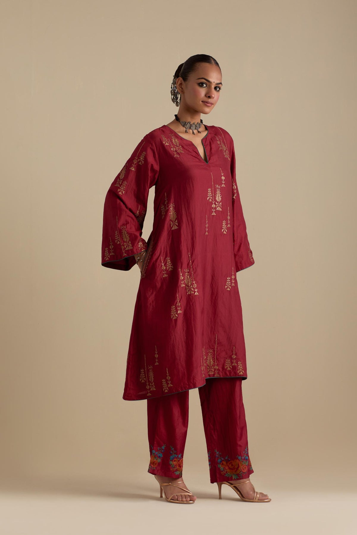 Barn red silk A-line short kurta set, highlighted with dull gold zari and sequins handwork.