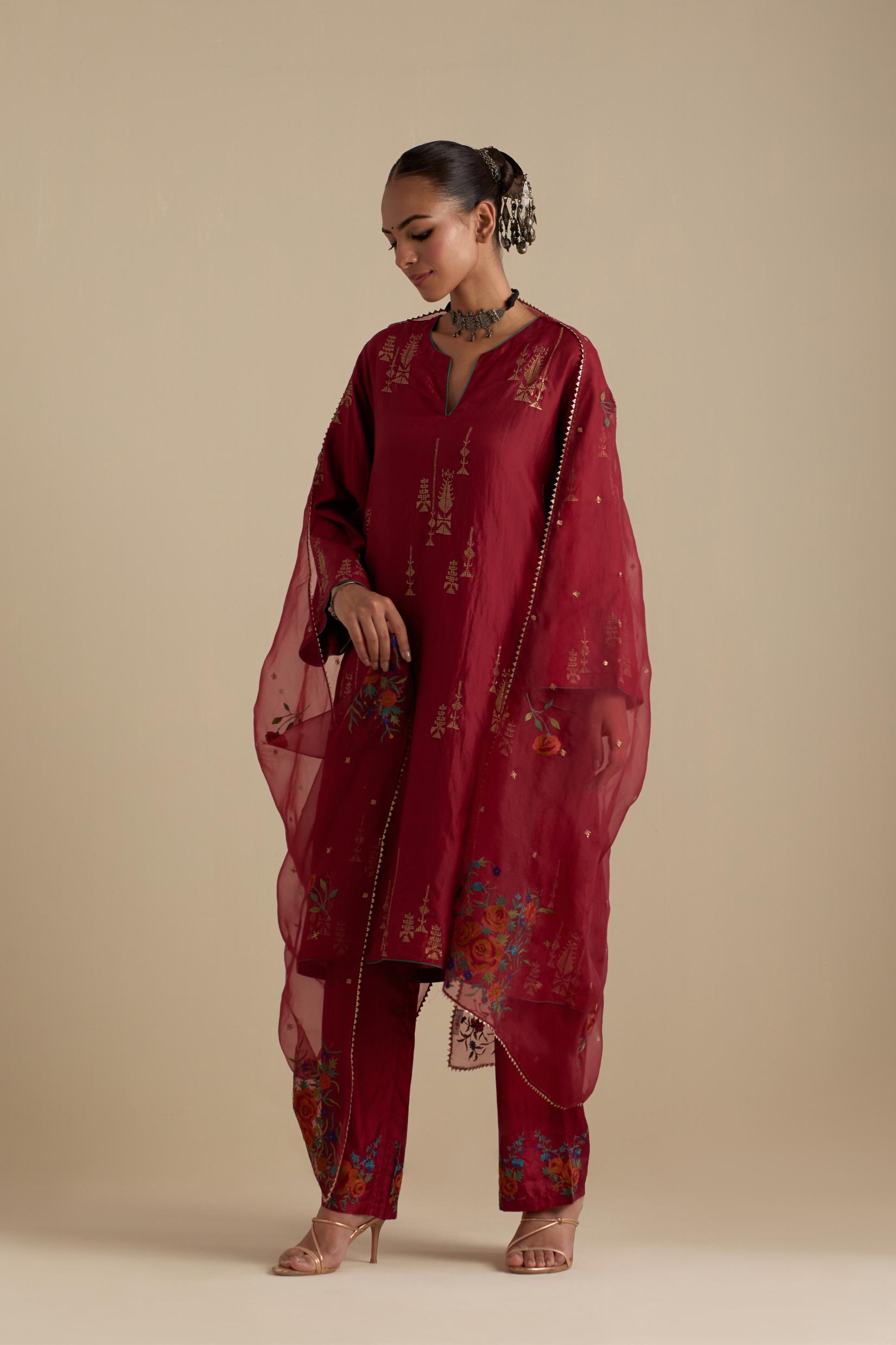 Barn red silk A-line short kurta set, highlighted with dull gold zari and sequins handwork.