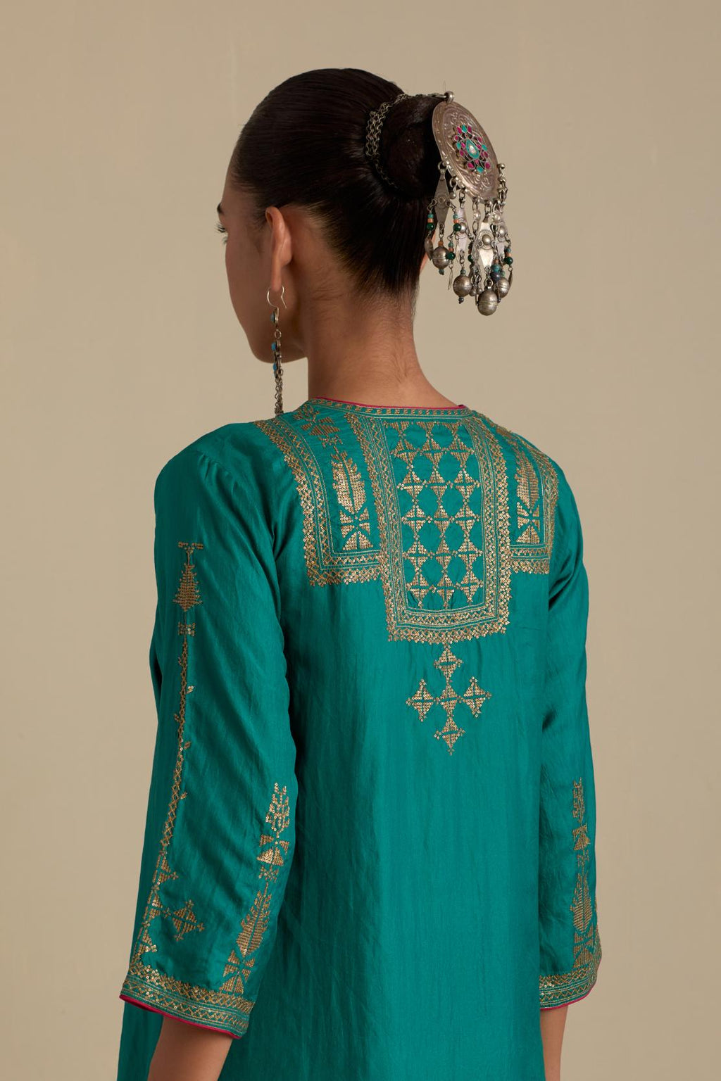 Persian green silk straight kurta set, highlighted with dull gold zari and sequins handwork.