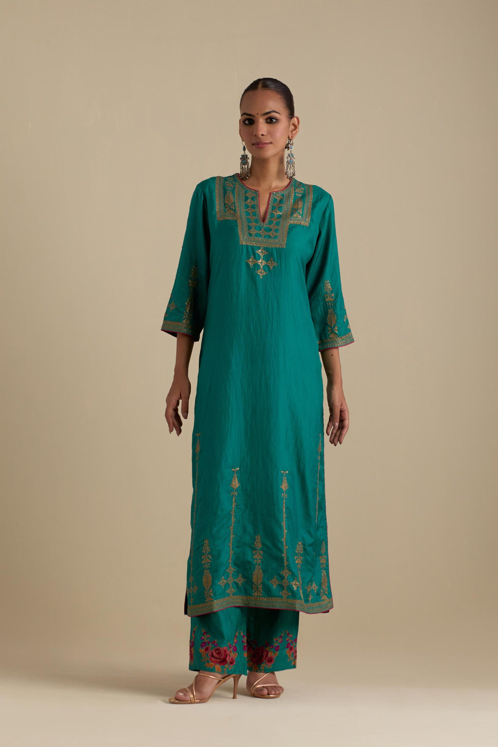 Persian green silk straight kurta set, highlighted with dull gold zari and sequins handwork.