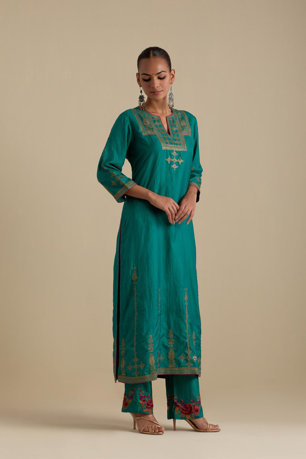 Persian green silk straight kurta set, highlighted with dull gold zari and sequins handwork.