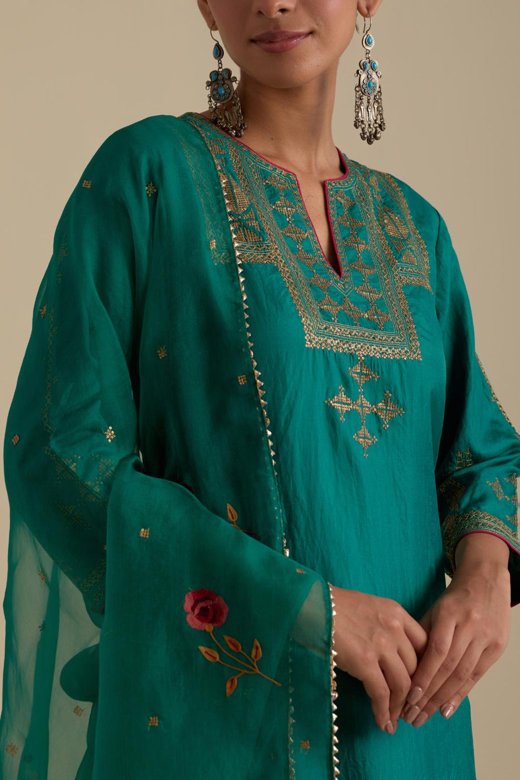 Persian green silk straight kurta set, highlighted with dull gold zari and sequins handwork.