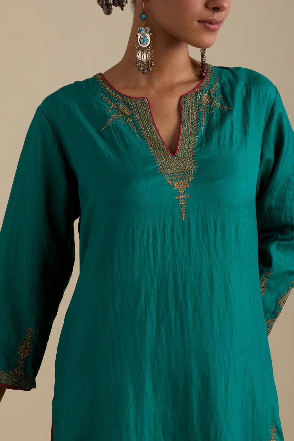 Persian green silk straight kurta set, highlighted with dull gold zari and sequins handwork