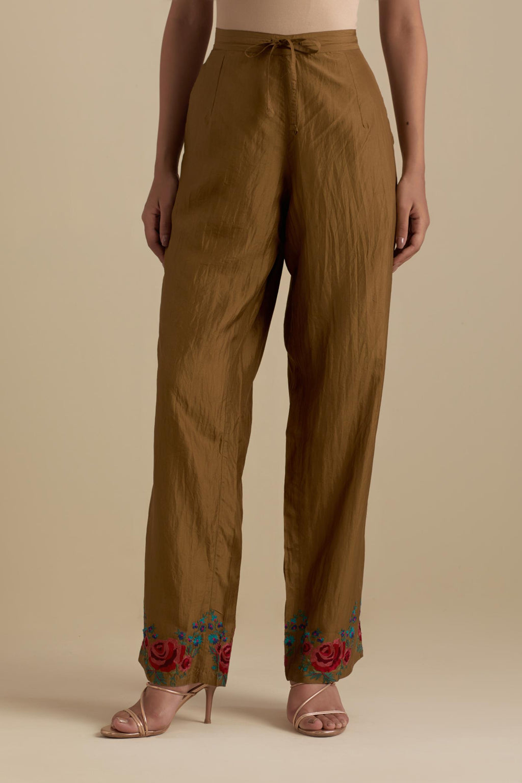 Olive silk straight pants with roses in thread embroidery at the hem.