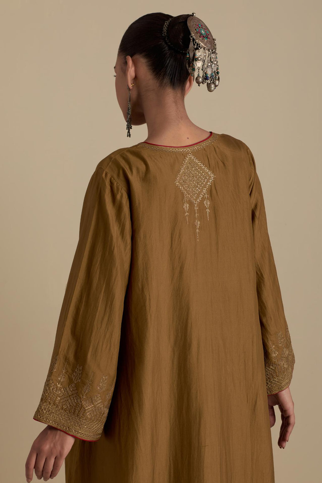 Olive knee length A-line kurta set, highlighted with dull gold zari and sequins handwork.